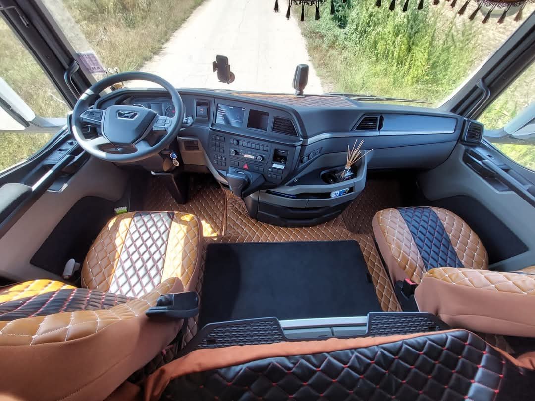 Tapis de sol en similicuir marron, housses de sieges en similicuir marrons sur les bords et noire en milieu, rideaux en alcantara marron camion Man sur mesure intérieure camion complet